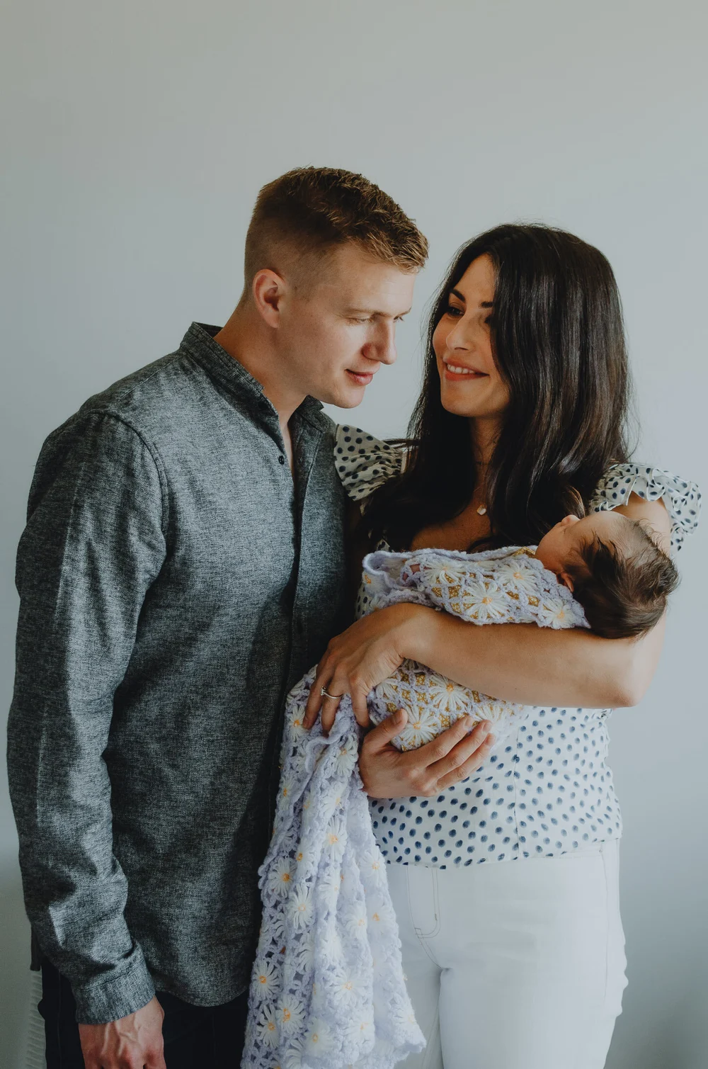 Mom and dad holding their newborn baby