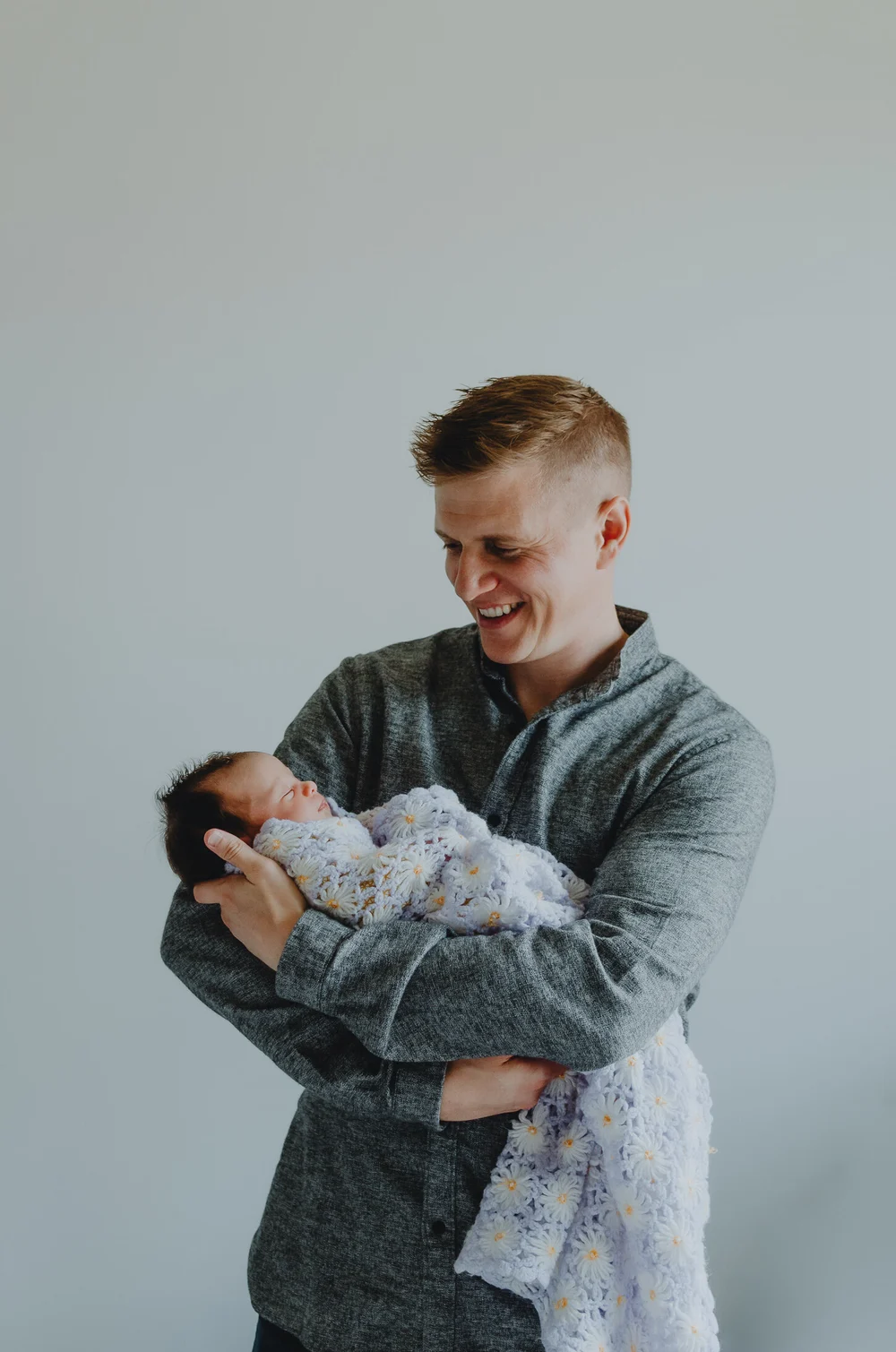 Dad holding his newborn baby