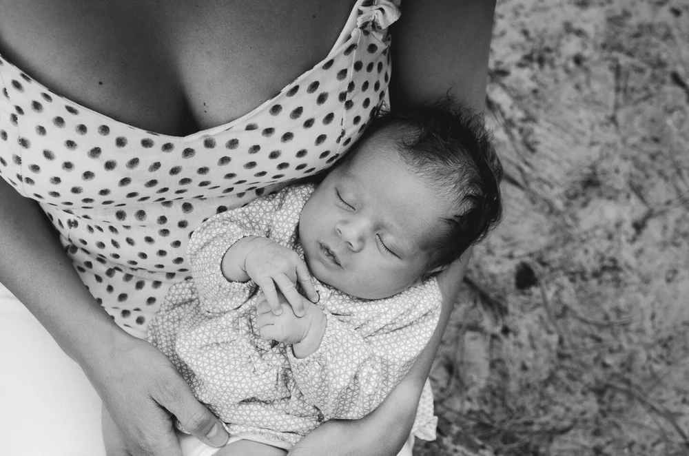 Newborn baby from the top, while mom is holding her