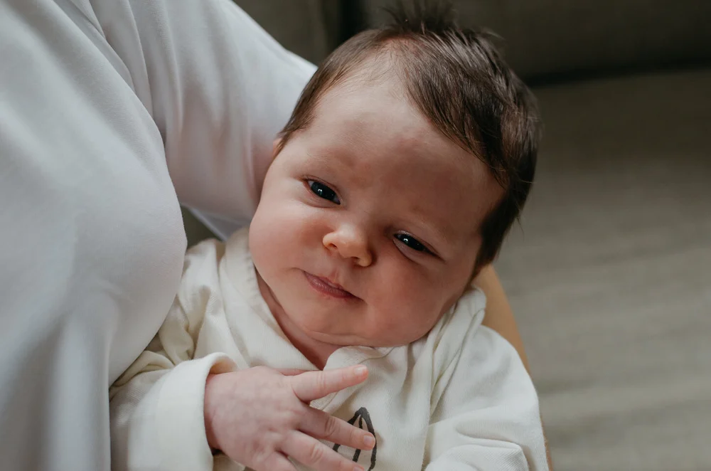 Newborn baby viewed from the top while mom is holding her