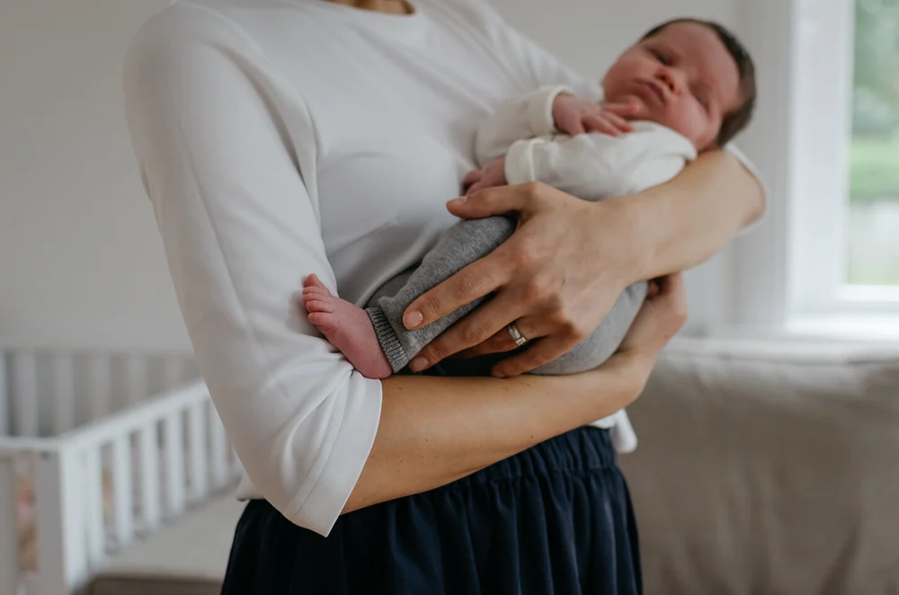 Mom holding her newborn baby in her arms