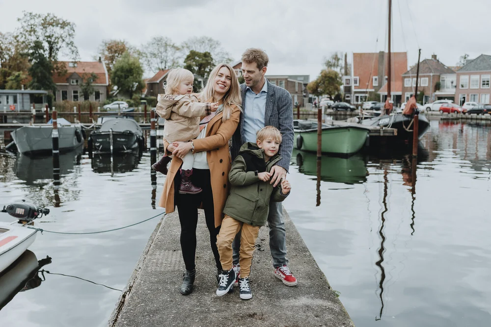 Dutch family standing next to the dock in Spaarndam, the Netherlands