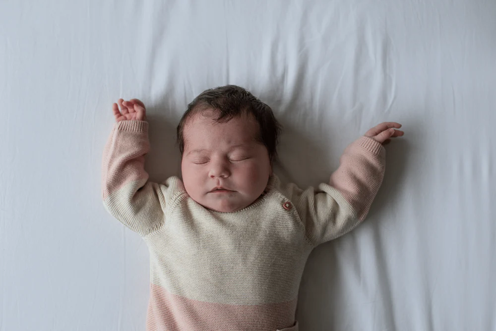 Newborn baby sleeping on a bed in Haarlem.