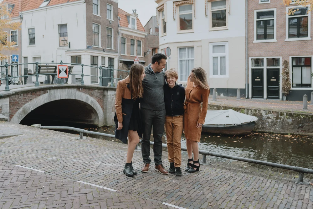 beautiful family standing next to a canal in Bakenessergracht in Haarlem